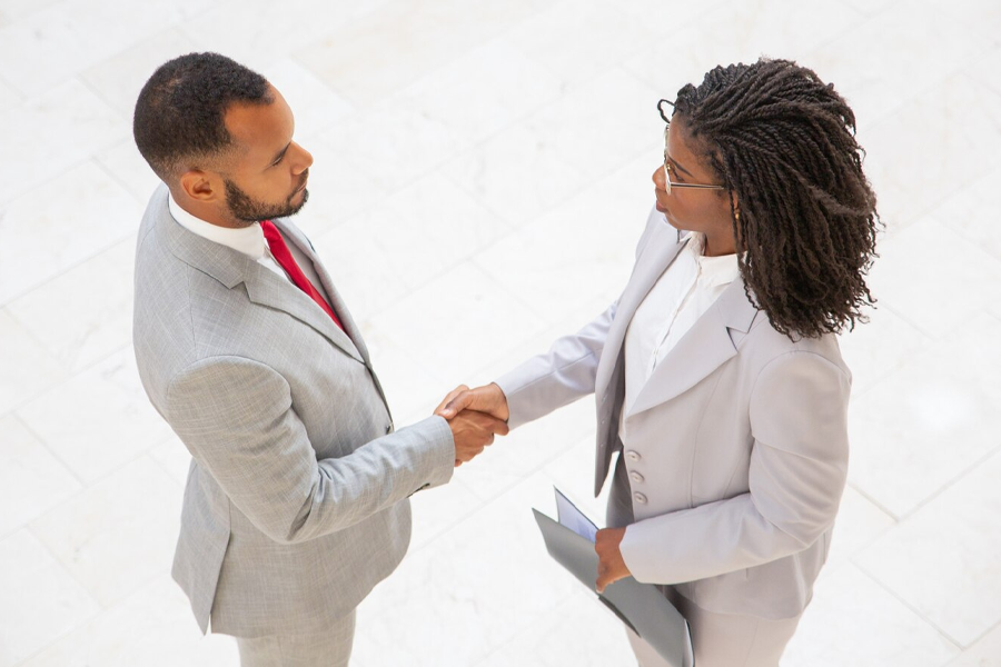 two people in business attire shaking hands