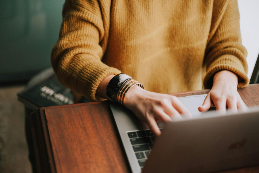 woman writes email on her laptop